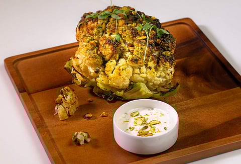 Whole Roasted Cauliflower with Pistachio Crumble and Green Onion Crème Fraiche