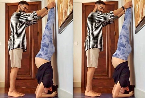 Anushka Sharma holds a Shirshasana