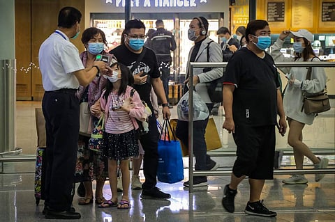 Travellers at Hong Kong Airport (AFP/Vivek Prakash)
