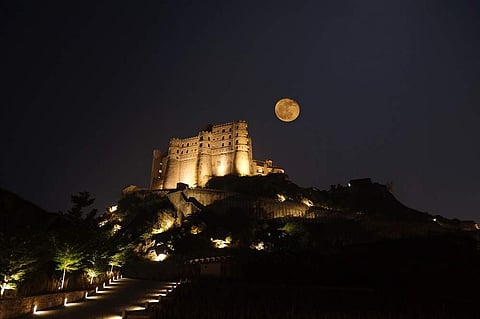An illuminated Alila Fort Bishangarh during full moon night