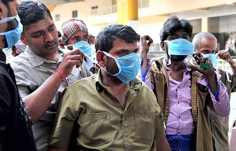 People being distributed masks as part of an awareness drive urging people to take precautionary measures against Coronavirus