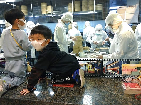 Children wear face masks to stay safe (AP Photo/Chiang Ying-ying)