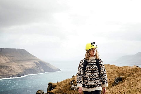 A tour guide for Visit Faroe Islands wears a helmet with a live-streaming camera (Kirstin Vang/Visit Faroe Islands via AP)