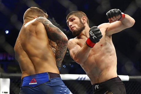 Russian UFC fighter Khabib Nurmagomedov (right; AP Photo/Mahmoud Khaled, File)