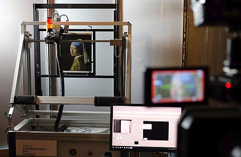 A scanner studies Vermeer's masterpiece (AP Photo/Mike Corder, FILE)