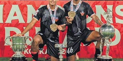 Muhammed Nemil Vailiyattil (left) and Christy Davis with the Durand Cup trophy after FC Goa beat Mohammedan SC in Kolkata on Sunday
