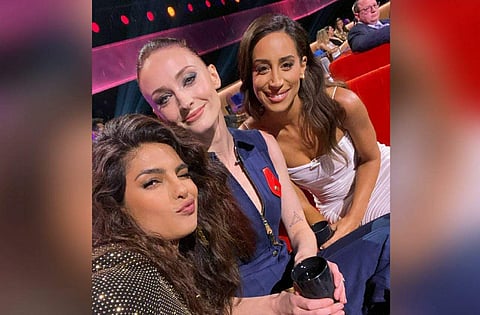 In the picture, Priyanka is seen taking a selfie while posing with Danielle and Sophie, their father-in-law is seen seated at a distance and focused on what's happening on stage.