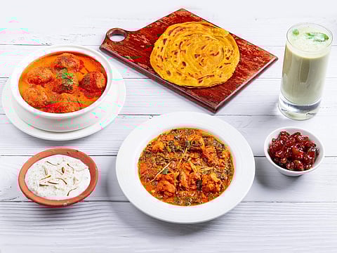 (L-R, clockwise) Doodhi Kofta Saalan, Kacchi Haldi Paratdar Paratha, Dhua Chaas, Amla ki Launji, Murgh Moringa and Muletthi Badam Kheer