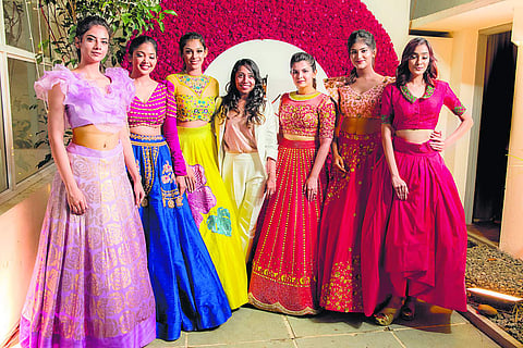 Sruthi Kannath flanked by models at her boutique launch