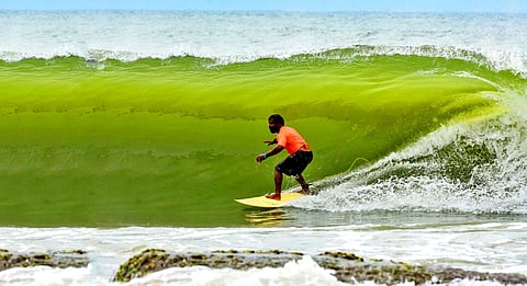 Murthy's first surfboard was a broken window made of wood, over 21 years ago