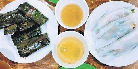 Soft rice paper rolls and banana leaf wraps stuffed with meat and veggies