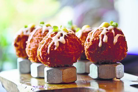 Semiya Upma Arancini balls served atop metal nut bolts!