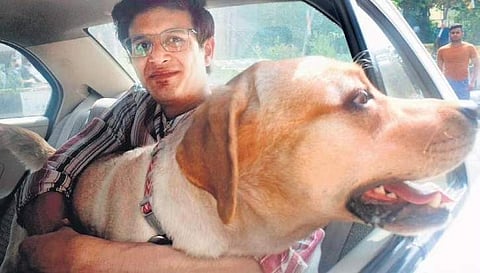 Sumit Singh with his pet and happy passenger Max in Singh’s taxi