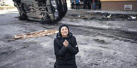 An elderly woman wailing in Bucha
