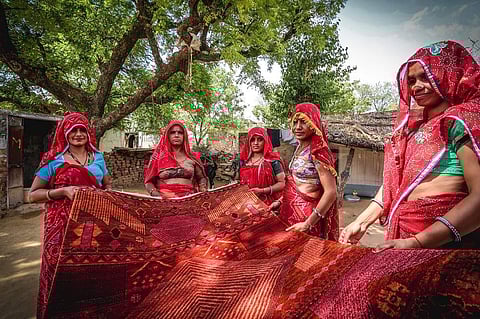 Artisans holding a rug