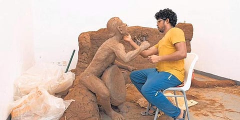 Artist Ashis Kumar Palei gives finishing touches to a piece of art