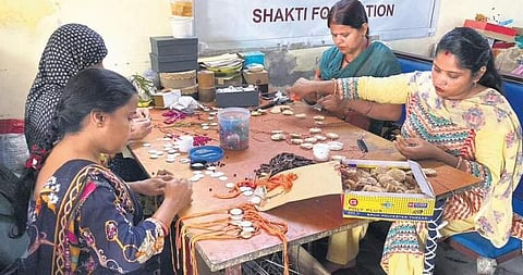 Gulmeher artisans crafting rakhis.