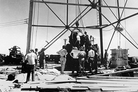 In frame: Scientists and other workers rig the world's first atomic bomb to raise it up onto a 100-foot tower at the Trinity Test Site