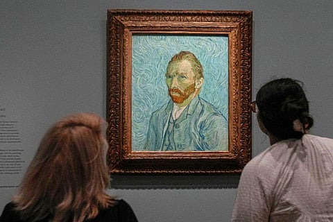 People look at Vincent Van Gogh's oil on canvas painting, Self-portrait, 1889