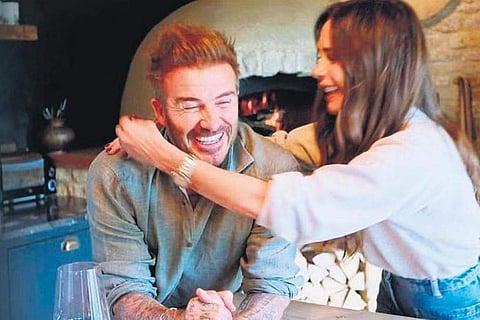 David Beckham with wife and fashion designer Victoria at home