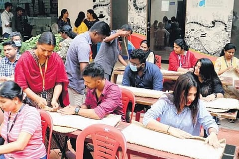 The employees of EY GDS engaged in coir grow bags making with training from National Coir Research and Management Institute staff
