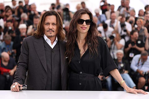 Johnny Depp and Maiwenn pose for photographers at the photo call for the film Jeanne du Barry