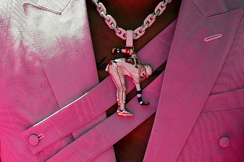 Atlanta Braves' Ronald Acuña Jr. wears a necklace with a figure of him during the baseball All-Star Game red carpet show