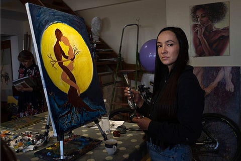 Iryna Farion, whose husband Oleksandr Alimov, a soldier, was killed in a battle with tRussian troops, paints a picture in an art studio in Kyiv