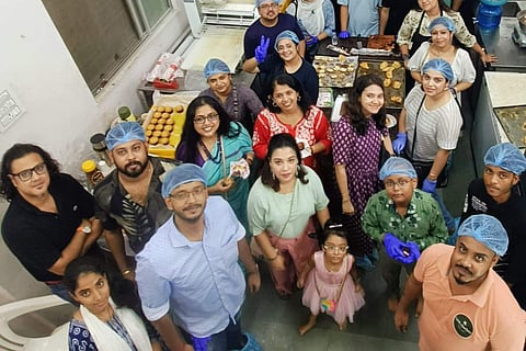 Participants pose in between baking