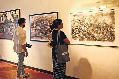 Visitors at PR Sugathan's exhibition ‘Out of the Black’ in Kochi