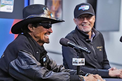 In frame: NASCAR legend Richard Petty, left, answers a question during a news conference as his son Kyle Petty looks on
