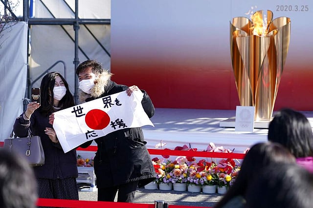 <em>The Olympic 'Flame of Recovery' display ceremony in Iwaki, northern Japan (AP Photo/Eugene Hoshiko)</em>