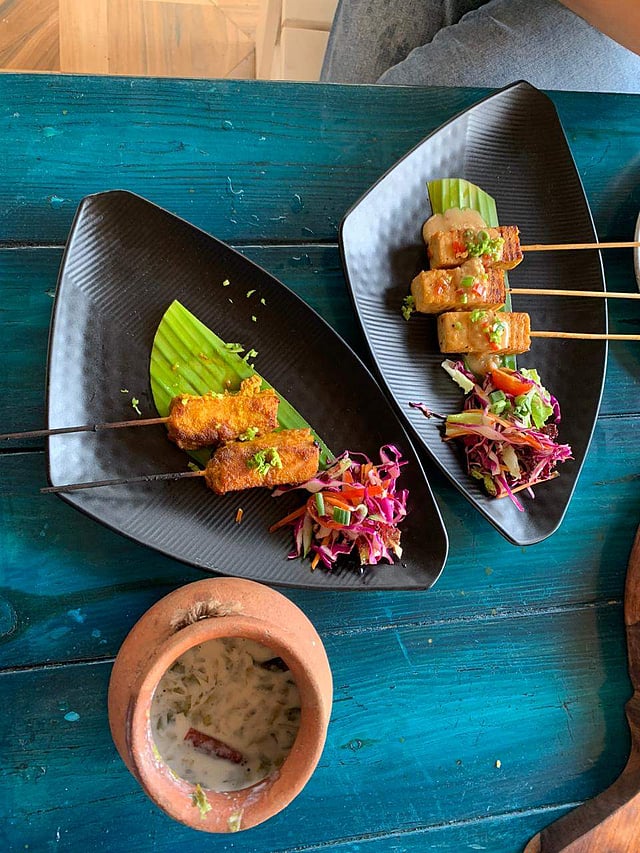 <em>Hanoi fish and tofu satays alongside a Sand & Pot cocktail</em>