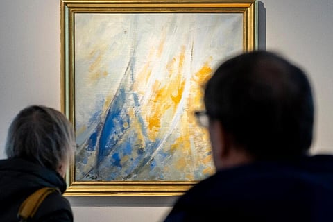 In frame: People view a painting by Denmark's Queen Margrethe on display at Bruun Rasmussen Auctions