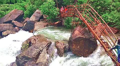 Mawryngkhang bamboo bridges across a waterfall