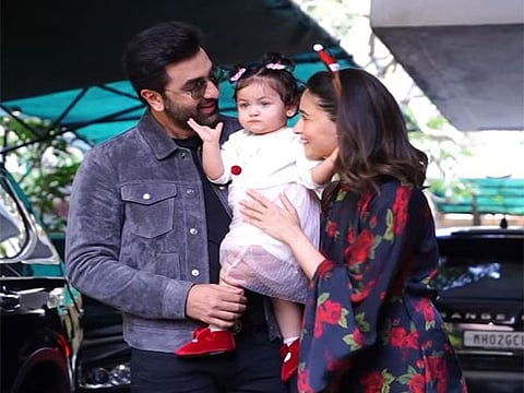 Ranbir Kapoor holds daughter Raha close as he and Alia Bhatt return from the Ambani pre-wedding