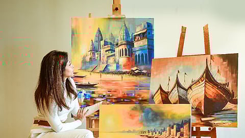 Nikita with a few of her paintings