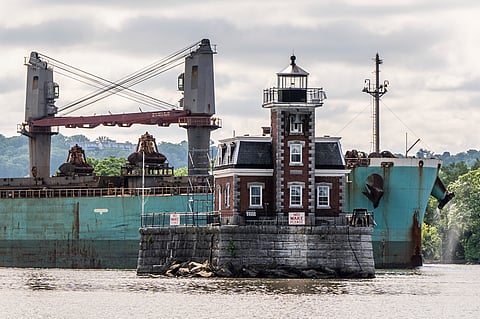 A ship passes the Hudson Athens Lighthouse,