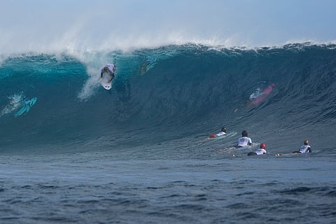 Alan Cleland Quinonez, of Mexico, drops in on a wave as he surfs during a training day ahead of the 2024 Summer Olympics surfing competition on July 23 in Teahupo'o, Tahiti
