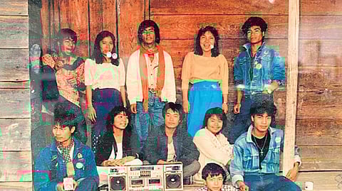 Lamka people posing around a music system