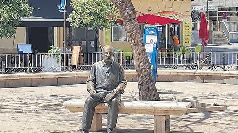 A bronze statue of the artist