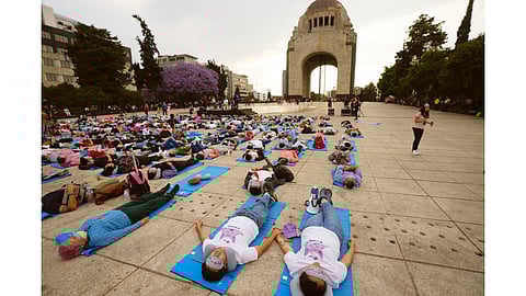 People lie sprawled out at the base of the iconic Monument to the Revolution to take a nap, in Mexico City (March 15, 2024) in commemoration of World Sleep Day
