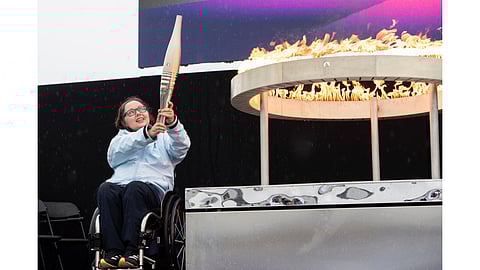 British Paralympian Helene Raynsford holds the Paralympic Torch during the flame lighting ceremony in Stoke Mandeville, England, widely considered the birthplace of the Paralympic Games (Aug. 24, 2024)
