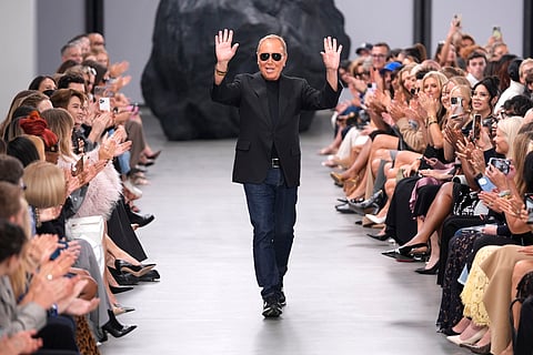 Designer Michael Kors waves to the crowd at the end of the Michael Kors Collection spring/summer 2025 fashion show as part of New York Fashion Week on Sept. 10, 2024, in New York