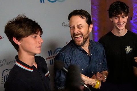 Jason Carter (center) grandson of President Jimmy Carter, with his sons, Henry Lewis Carter (right) and Thomas Clyde Carter (left) attends the 'Jimmy Carter 100: A Celebration in Song' concert at the Fox Theatre on Sept. 17, 2024, in Atlanta