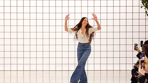 Designer Chemena Kamali accepts applause after the Chloe Spring/Summer 2025 collection