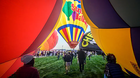 ‘Magical’ flotilla of hot air balloons take flight at international fiesta amid warm temperatures