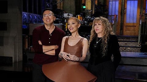 This image released by NBC shows cast member Bowen Yang, from left, host Ariana Grande, and musical guest Stevie Nicks during promos for the upcoming Saturday Night Live