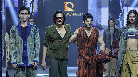 Pawan Sachdeva and models donning ensembles from the collection