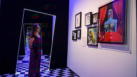 A member of staff poses at The World of Tim Burton exhibition at the Design Museum, in London,